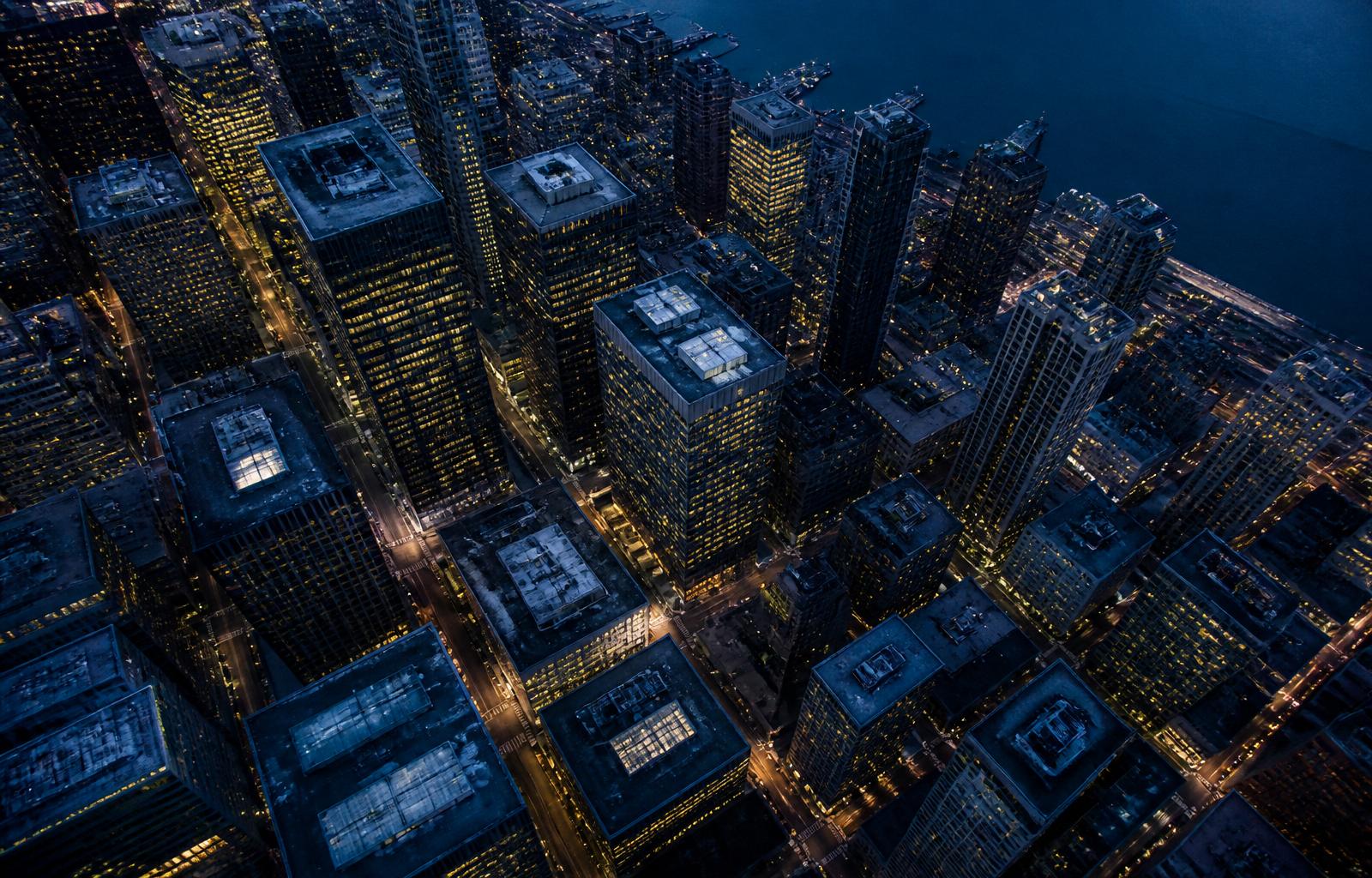 A financial district at twilight, the lights just coming on